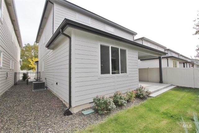 rear view of house featuring cooling unit and a patio area