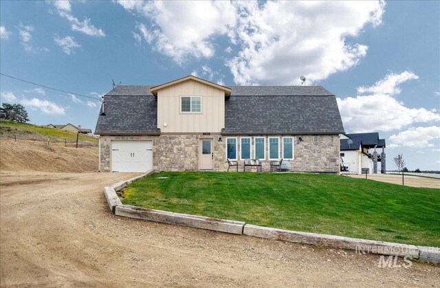 8618 Latimore Ln, Middleton, ID 83644 - view of front of property with stone siding, dirt driveway, a front lawn, a garage, and board and batten siding