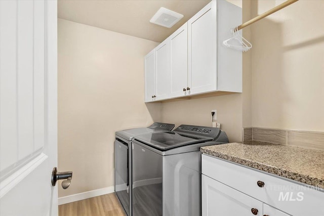 8618 Latimore Ln, Middleton, ID 83644 - laundry area with separate washer and dryer, cabinet space, light wood-style flooring, and baseboards