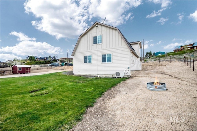 8618 Latimore Ln, Middleton, ID 83644 - view of side of property featuring board and batten siding, a fire pit, an outdoor structure, and a storage unit