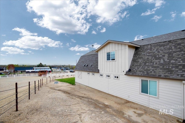 8618 Latimore Ln, Middleton, ID 83644 - view of side of home featuring board and batten siding, fence, and roof with shingles