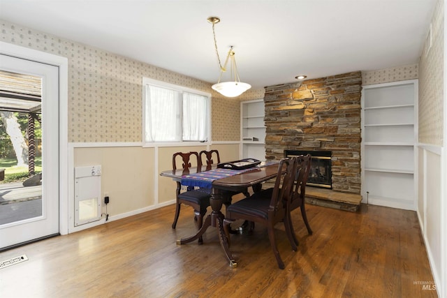 1719 S Gekeler Ln, Boise, ID 83706 - dining area featuring wallpapered walls, plenty of natural light, wood finished floors, a stone fireplace, and baseboards