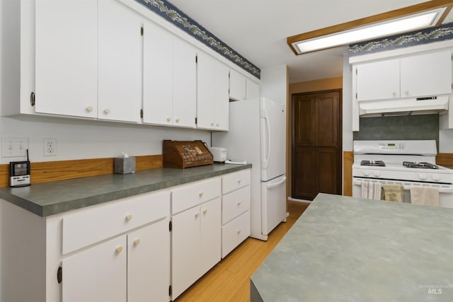 1719 S Gekeler Ln, Boise, ID 83706 - kitchen featuring white appliances, under cabinet range hood, light wood-type flooring, white cabinets, and dark countertops