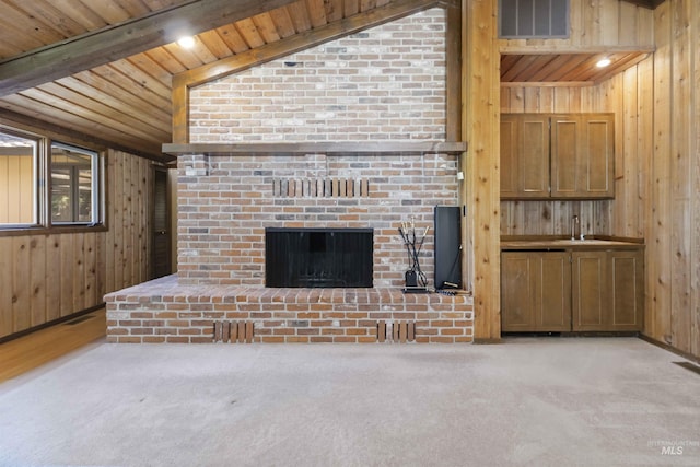 1719 S Gekeler Ln, Boise, ID 83706 - unfurnished living room featuring wood walls, a brick fireplace, wooden ceiling, carpet, and a sink