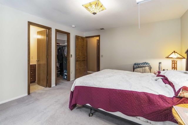 1719 S Gekeler Ln, Boise, ID 83706 - bedroom featuring a walk in closet, light colored carpet, ensuite bath, a closet, and baseboards
