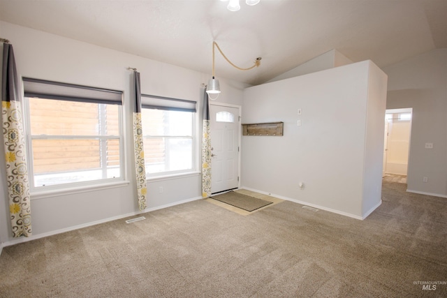 carpeted spare room featuring lofted ceiling