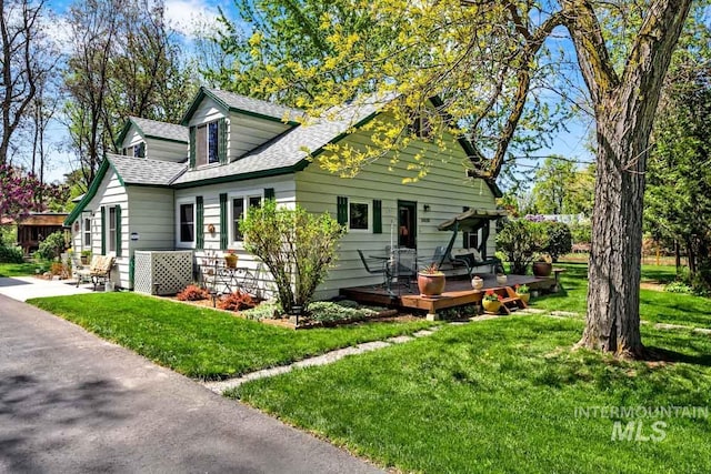 10838 W Southerland St, Boise, ID 83709 - exterior space featuring a shingled roof, a front lawn, and a wooden deck