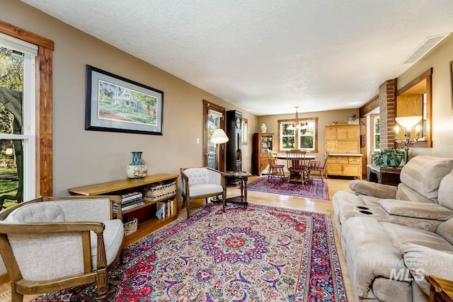 10838 W Southerland St, Boise, ID 83709 - living area featuring a textured ceiling, wood finished floors, and visible vents