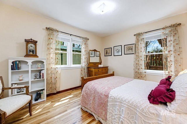 10838 W Southerland St, Boise, ID 83709 - bedroom featuring baseboards, multiple windows, and wood finished floors