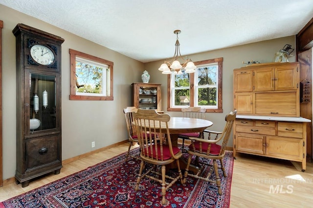 10838 W Southerland St, Boise, ID 83709 - dining space with light wood-style floors, baseboards, and a chandelier