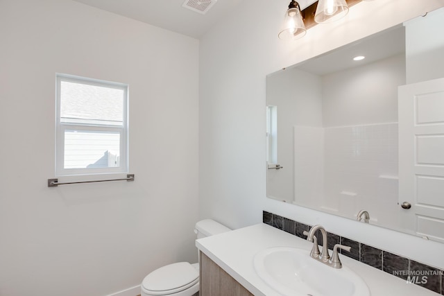 bathroom featuring vanity and toilet