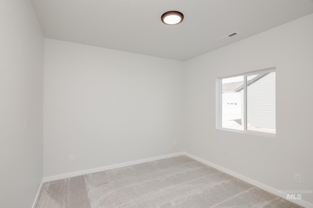 empty room featuring light colored carpet