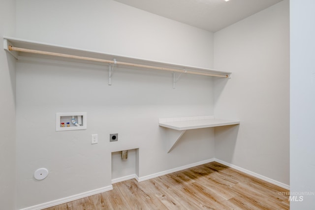 washroom with electric dryer hookup, light hardwood / wood-style flooring, and washer hookup