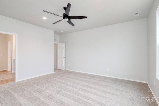 spare room with light carpet and ceiling fan