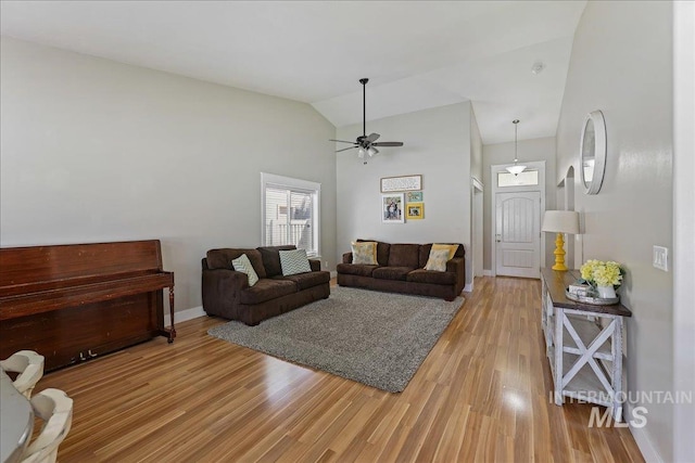 1879 Prairie View Way, Middleton, ID 83644 - living area featuring light wood finished floors, ceiling fan, high vaulted ceiling, and baseboards