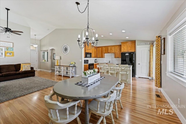 1879 Prairie View Way, Middleton, ID 83644 - dining area with lofted ceiling, a ceiling fan, a chandelier, arched walkways, and baseboards