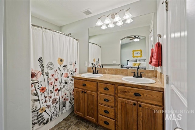 1879 Prairie View Way, Middleton, ID 83644 - bathroom with double vanity, ceiling fan, curtained shower, and ensuite bathroom