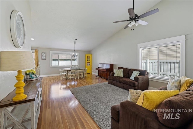 1879 Prairie View Way, Middleton, ID 83644 - living room with a chandelier, wood finished floors, a ceiling fan, baseboards, and high vaulted ceiling