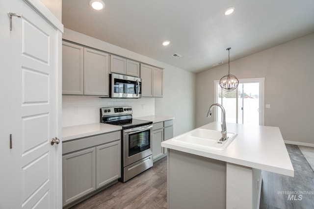 kitchen featuring gray cabinetry, sink, appliances with stainless steel finishes, and a notable chandelier