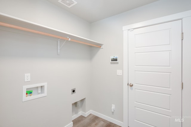 laundry area featuring hookup for a washing machine, electric dryer hookup, and hardwood / wood-style flooring