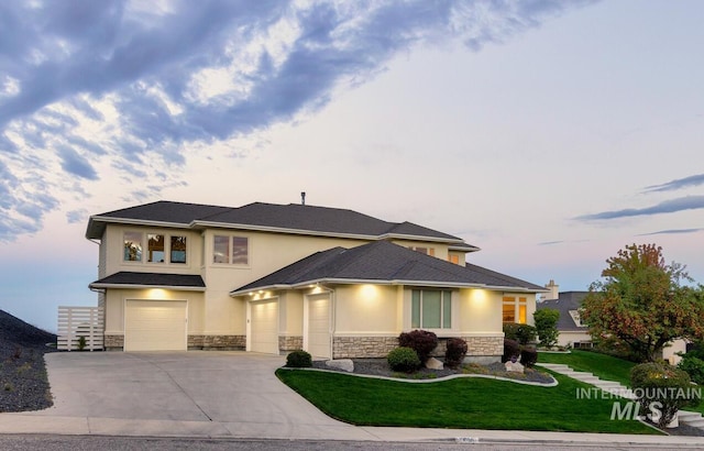 prairie-style house with a lawn and a garage