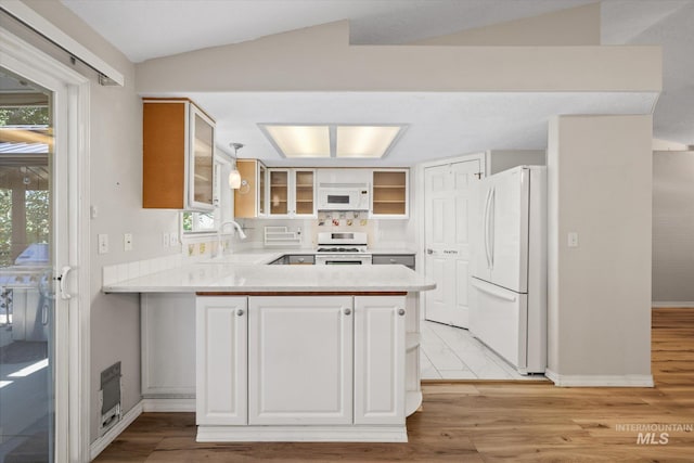 2800 Taylor Ct, Nampa, ID 83686 - kitchen with white appliances, a peninsula, glass insert cabinets, light countertops, and lofted ceiling