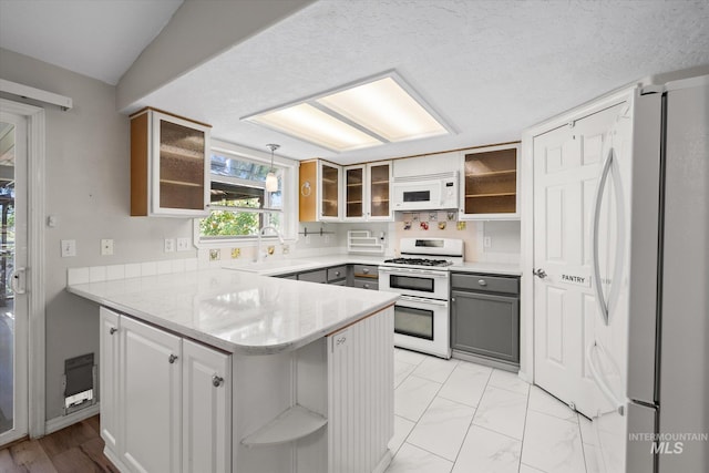 2800 Taylor Ct, Nampa, ID 83686 - kitchen featuring white appliances, a peninsula, open shelves, gray cabinetry, and glass insert cabinets