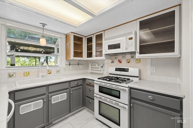 2800 Taylor Ct, Nampa, ID 83686 - kitchen featuring white appliances, gray cabinets, healthy amount of natural light, and light marble finish floors