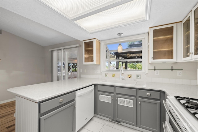 2800 Taylor Ct, Nampa, ID 83686 - kitchen featuring gray cabinetry, white dishwasher, a peninsula, and light countertops