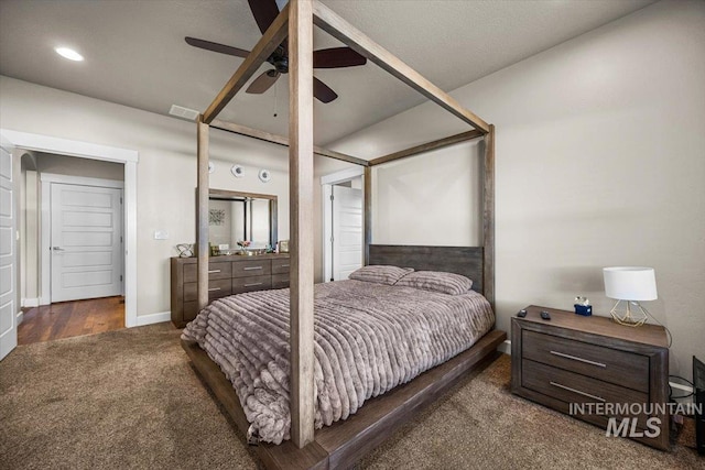 bedroom with ceiling fan and dark colored carpet