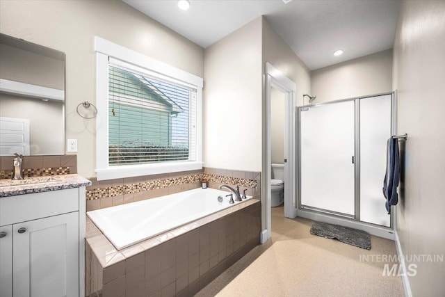 full bathroom featuring vanity, shower with separate bathtub, and toilet