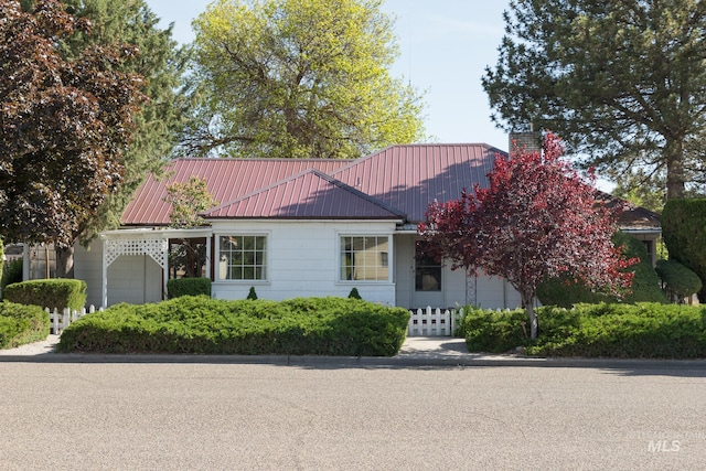 286 SW 3rd Ave, Ontario, OR 97914 - view of front facade with a garage, a chimney, and metal roof