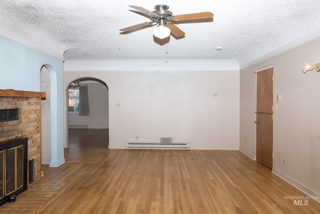 286 SW 3rd Ave, Ontario, OR 97914 - unfurnished living room with a textured ceiling, a ceiling fan, ornamental molding, a fireplace, and arched walkways