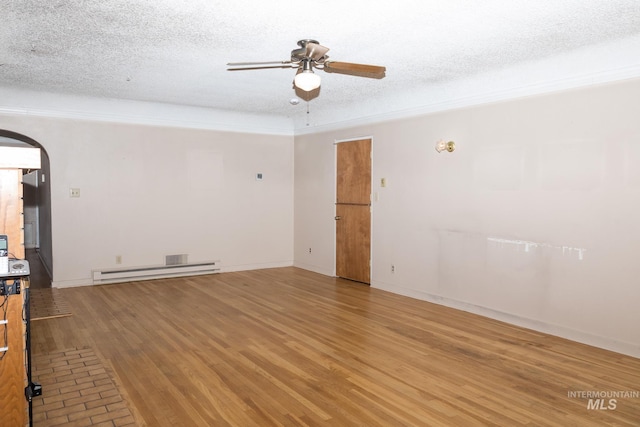 286 SW 3rd Ave, Ontario, OR 97914 - unfurnished room featuring arched walkways, a ceiling fan, baseboard heating, light wood-style floors, and a textured ceiling