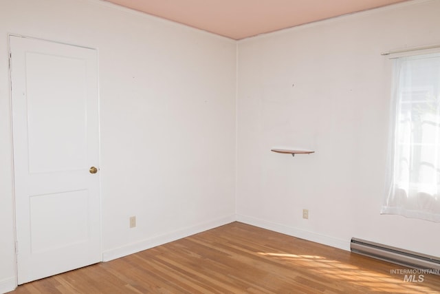 286 SW 3rd Ave, Ontario, OR 97914 - unfurnished room featuring a baseboard radiator, light wood-type flooring, crown molding, and baseboards