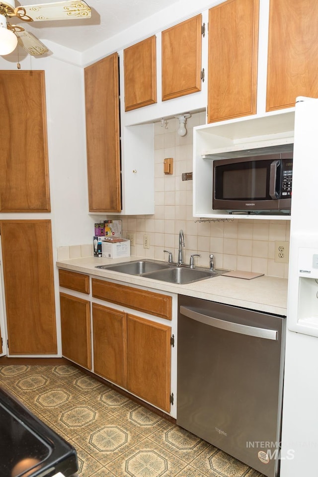 286 SW 3rd Ave, Ontario, OR 97914 - kitchen featuring appliances with stainless steel finishes, a sink, light countertops, backsplash, and brown cabinets