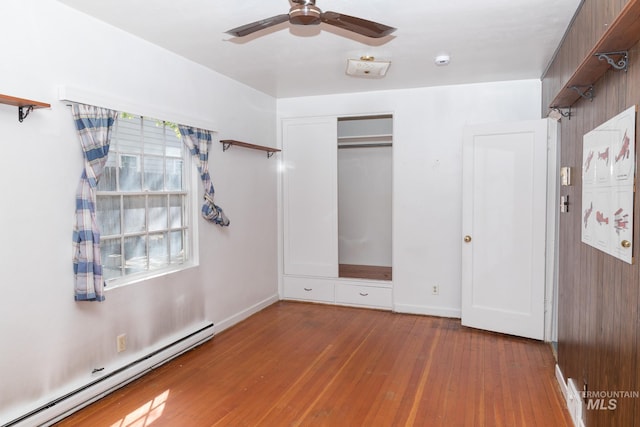 286 SW 3rd Ave, Ontario, OR 97914 - unfurnished bedroom featuring a baseboard heating unit, hardwood / wood-style flooring, baseboards, a closet, and ceiling fan