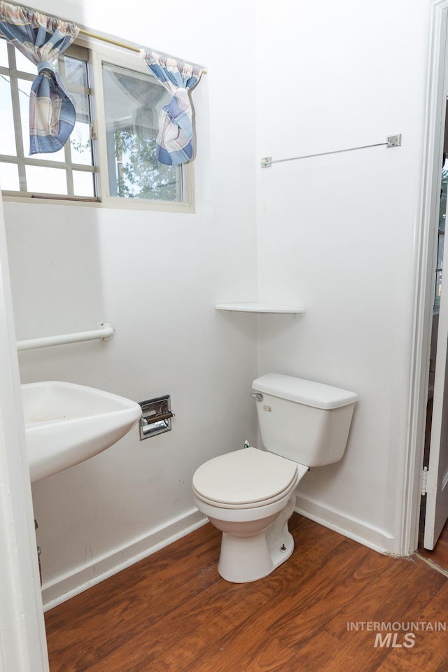 286 SW 3rd Ave, Ontario, OR 97914 - half bathroom featuring wood finished floors, toilet, and baseboards