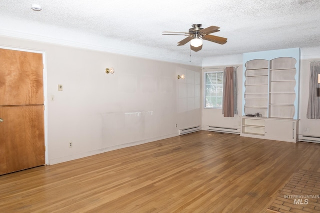 286 SW 3rd Ave, Ontario, OR 97914 - spare room featuring a textured ceiling, ceiling fan, a baseboard radiator, and wood finished floors