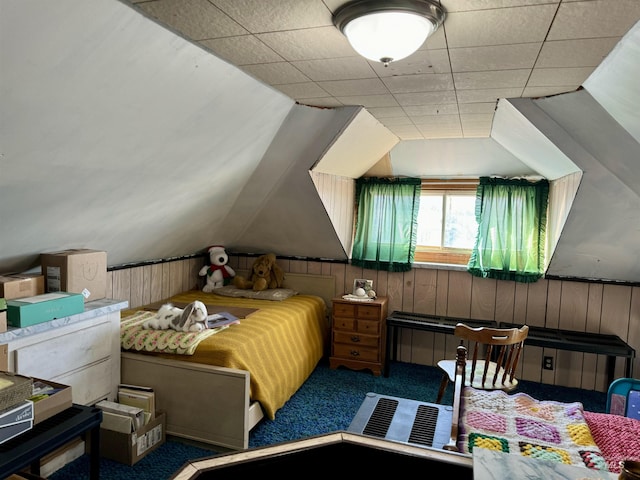 bedroom featuring wooden walls, carpet, and vaulted ceiling