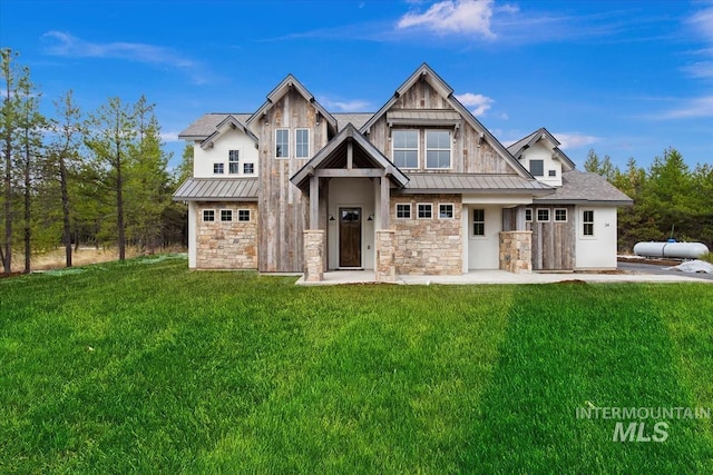 view of front of house with a standing seam roof, metal roof, and a front lawn