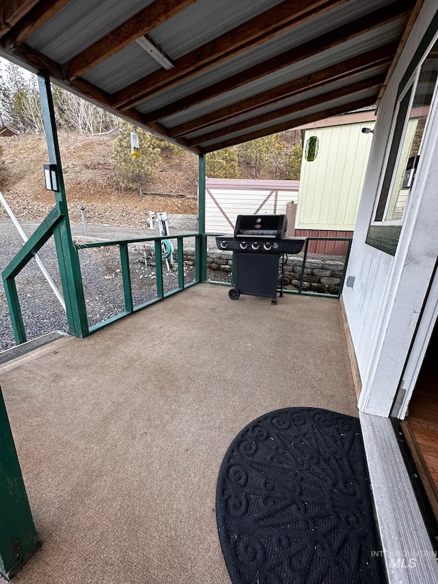 view of patio / terrace with a grill and an outbuilding