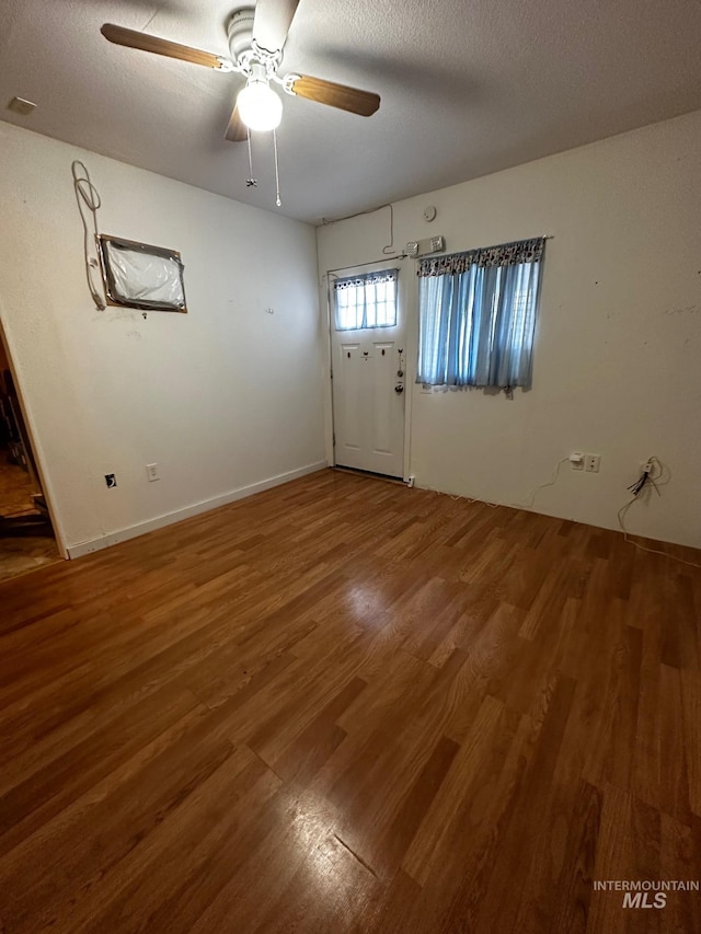 entryway featuring hardwood / wood-style floors, ceiling fan, and a textured ceiling