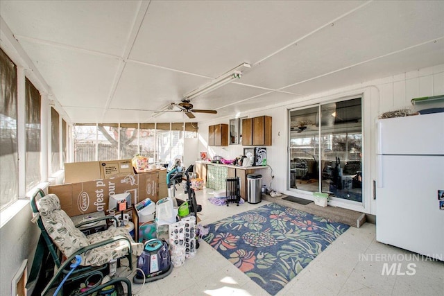 sunroom with a ceiling fan