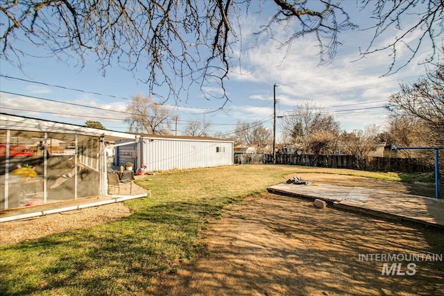 view of yard with an outdoor structure and fence