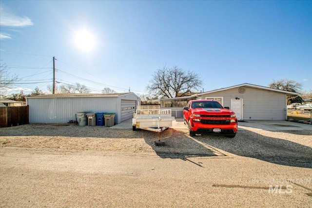 exterior space featuring driveway and fence