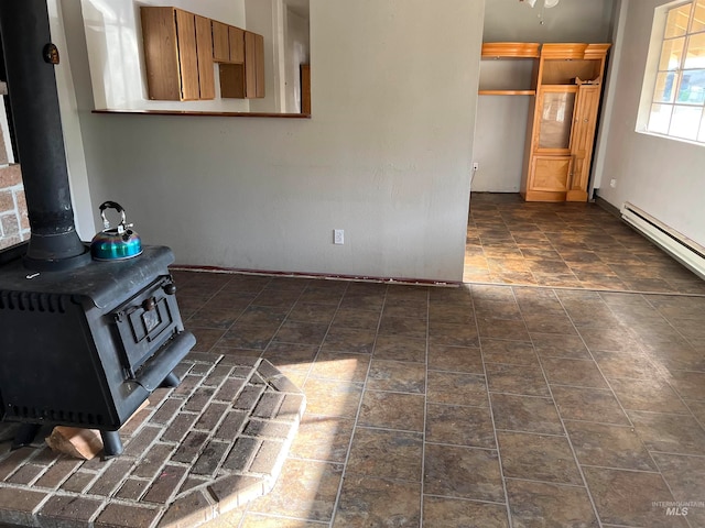 unfurnished living room featuring a wood stove