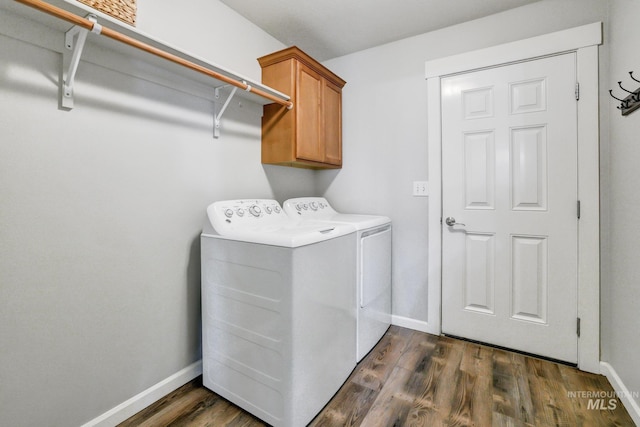 laundry area featuring dark hardwood / wood-style flooring, cabinets, and independent washer and dryer