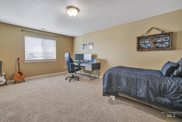 carpeted bedroom featuring a textured ceiling