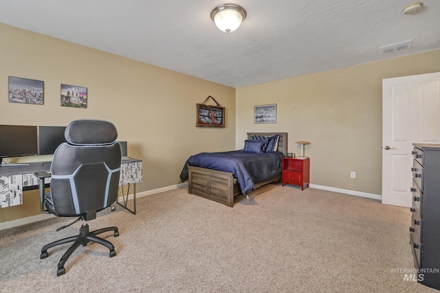 bedroom featuring light carpet and a textured ceiling